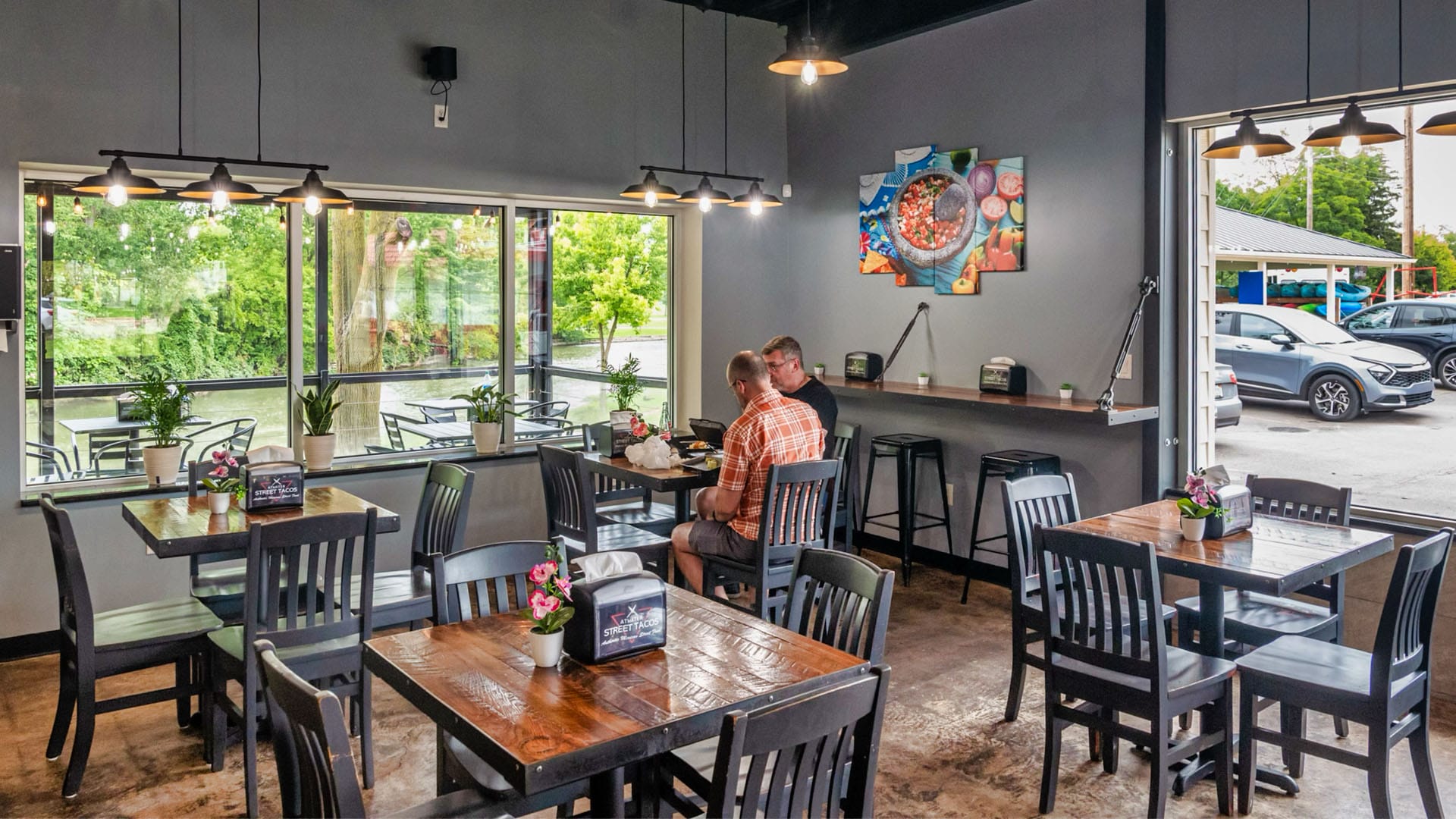 Riverside dining at Atwater Street Tacos in Flat Rock with both outdoor patio seating and indoor air-conditioned options available.