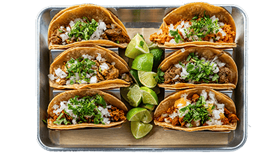 Authentic Mexican street tacos with marinated carne asada, al pastor, cilantro, onions, and salsa verde served on soft corn tortillas at Atwater Street Tacos Monroe MI