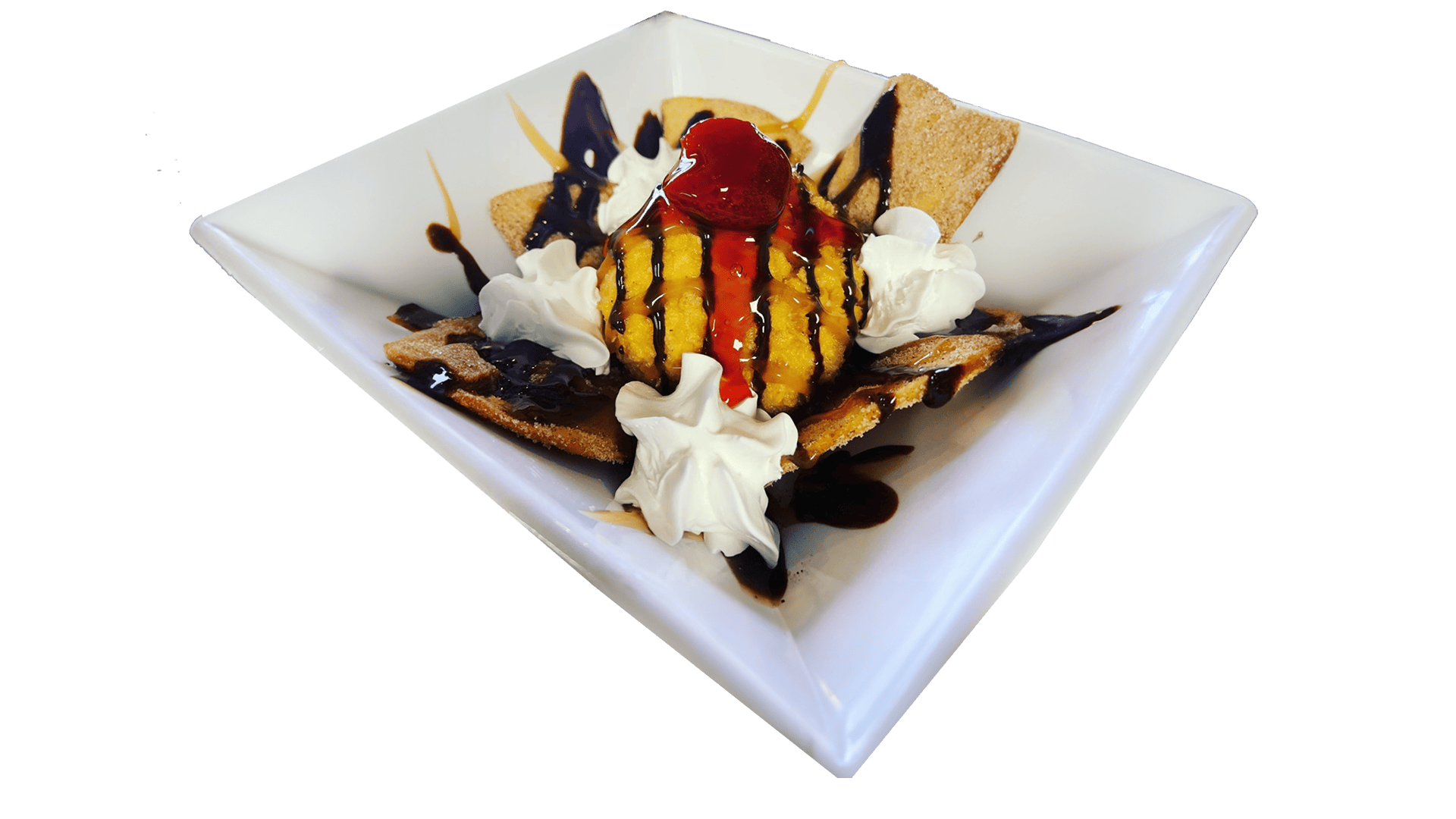 Scoop of fried ice cream with chocolate syrup and caramel, topped with whipped cream, served in a bowl on a wooden table.