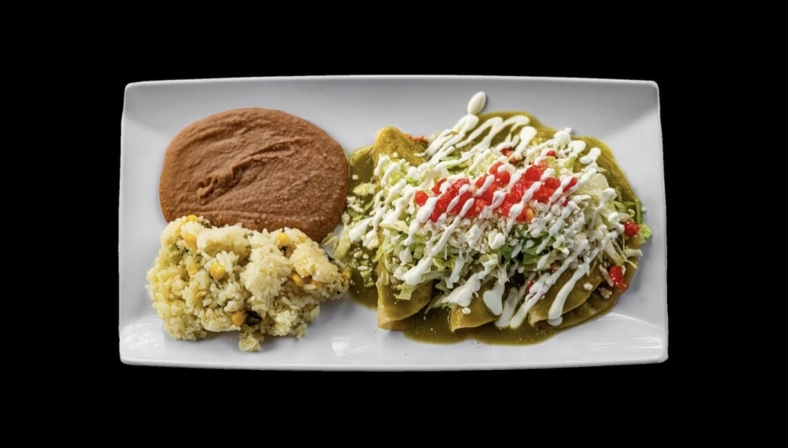 Plate of Chicken Enchiladas Verde with shredded chicken, verde sauce, queso fresco, lettuce, tomato, onion, served with rice and beans at Atwater Street Tacos in Flat Rock and Monroe, MI