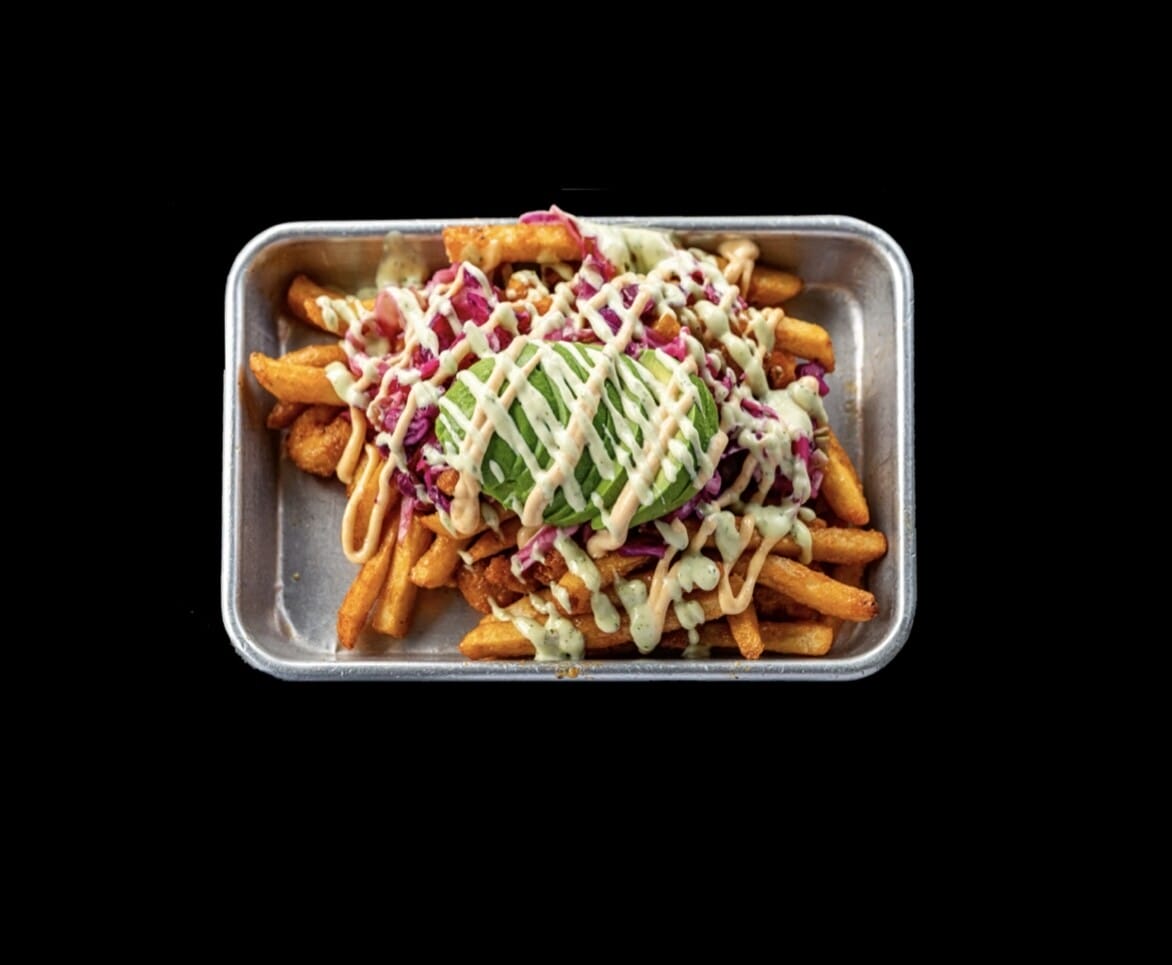 Plate of Cajun Shrimp Fries with hand-cut fries, seasoned shrimp, cabbage slaw, avocado, Sriracha aioli, and cilantro lime aioli from Atwater Street Tacos