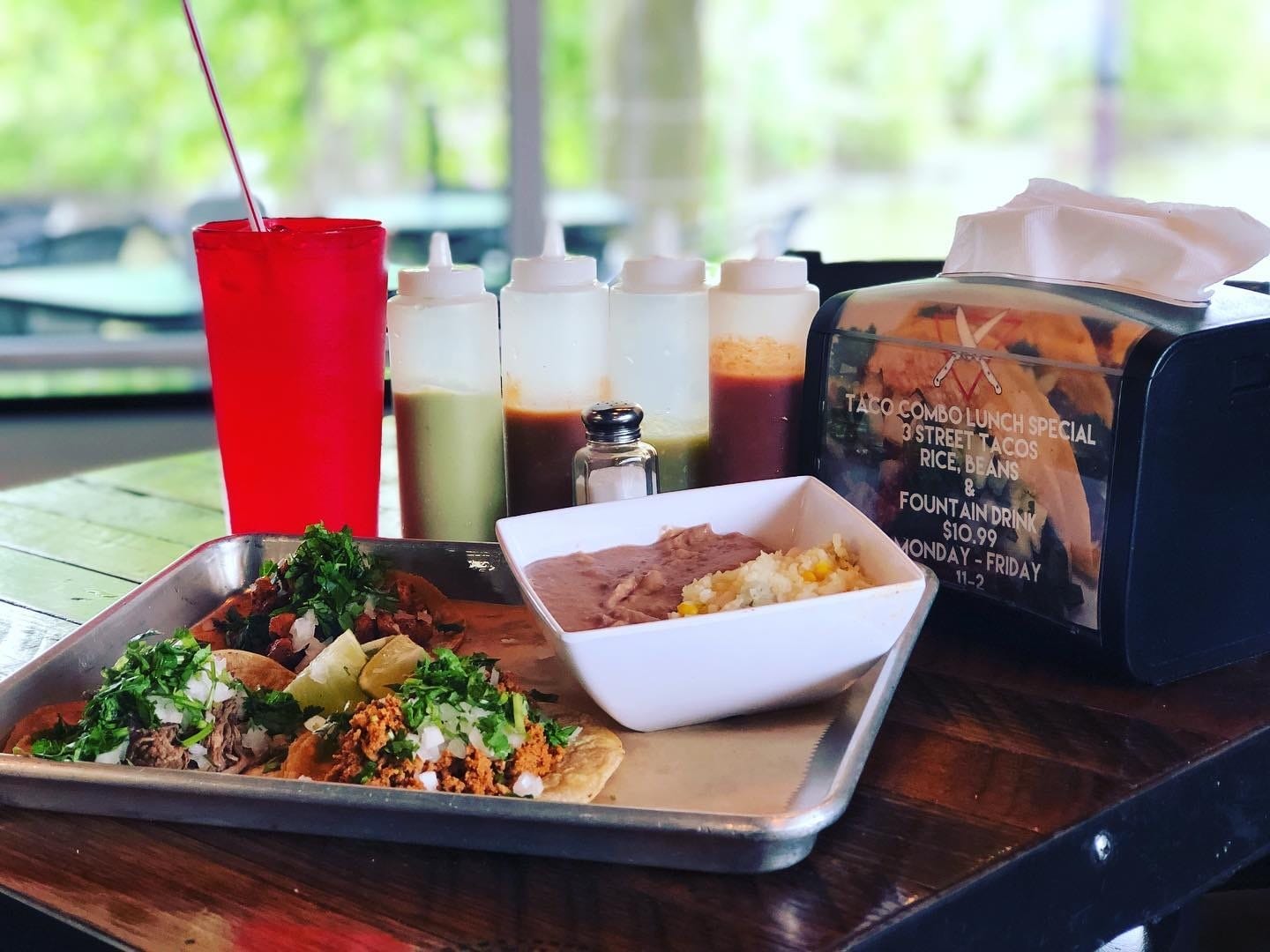 Image of three delicious tacos served with rice, beans, and a beverage, representing Atwater Street Tacos' 3 Taco Lunch Combo.