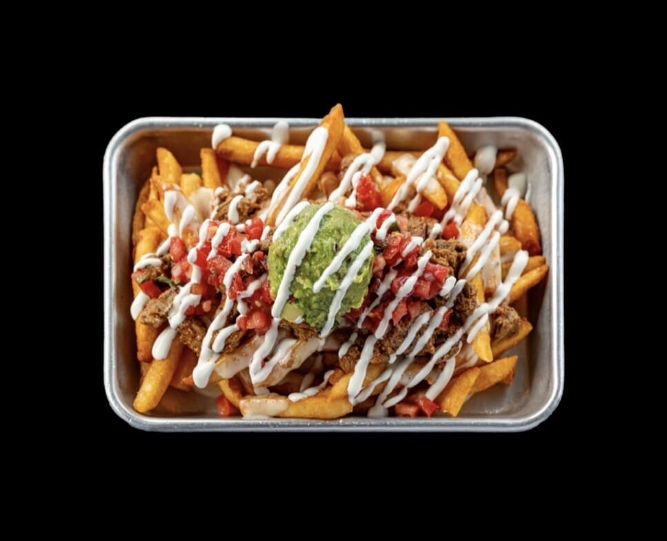 Plate of Asada Fries topped with marinated carne asada steak, pico de gallo, guacamole, and sour cream from Atwater Street Tacos Monroe MI and Flat Rock MI