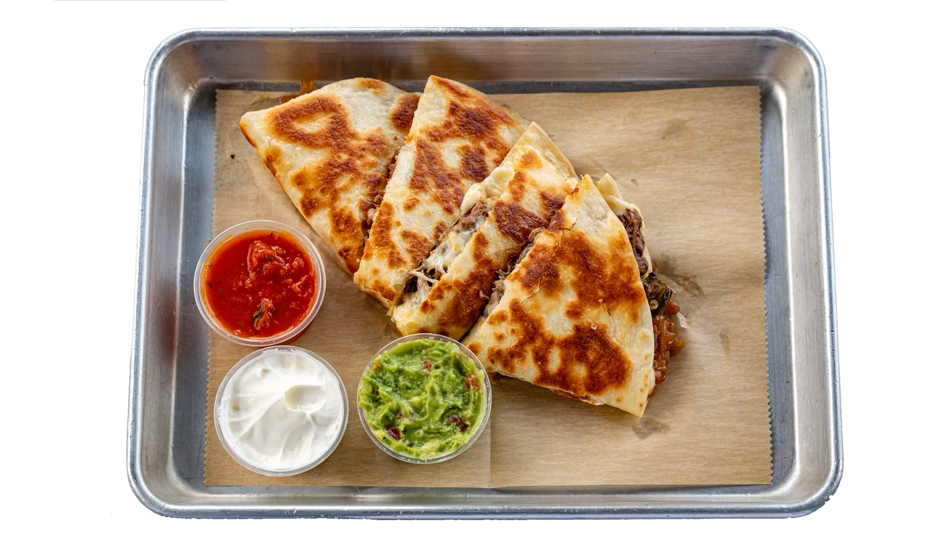 Grilled quesadilla with melted cheese, onions, jalapeños, and meat on a flour tortilla, served with guacamole, salsa, and sour cream.