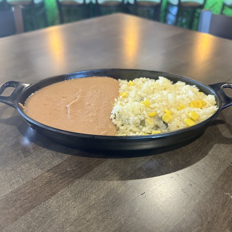 Freshly prepared Mexican Rice and Refried Beans with queso fresco and cilantro from Atwater Street Tacos in Monroe and Flat Rock, Michigan.